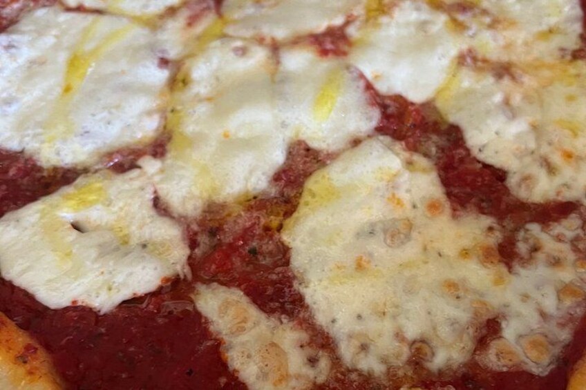 A close-up of a pizza with melted cheese and tomato sauce. 3