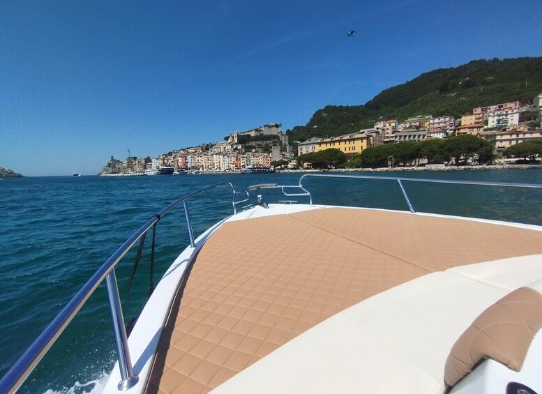 A boat's deck with a view of a coastal town and the sea. 4