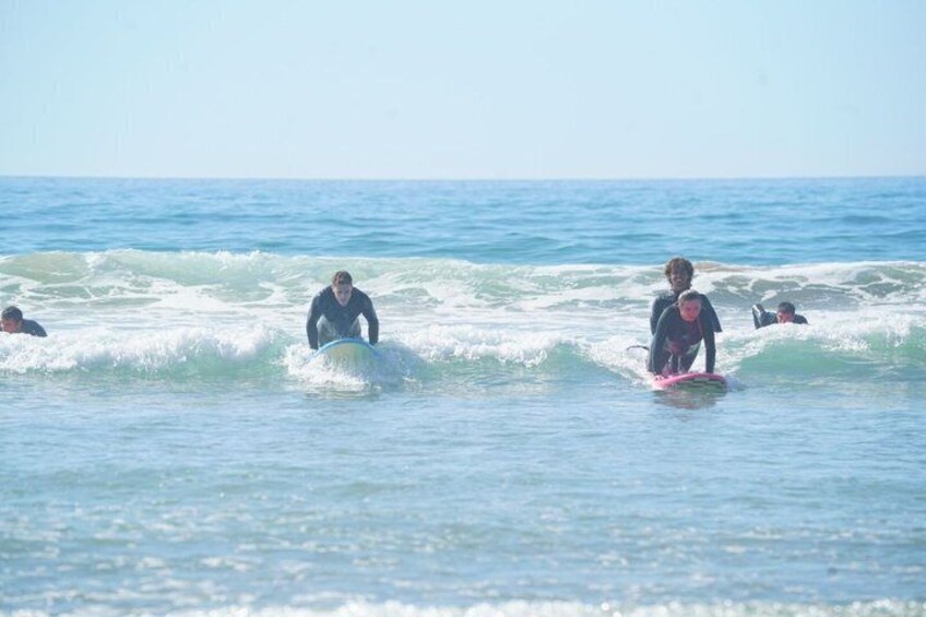 Surfers riding waves in the ocean. 2