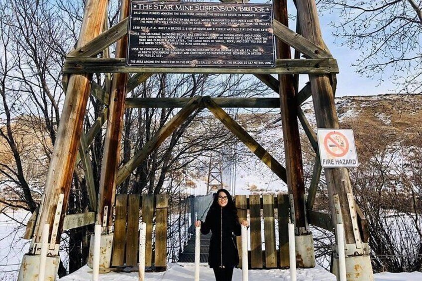 A wooden structure with a signboard, a no fire hazard sign, and a person standing in front. 3
