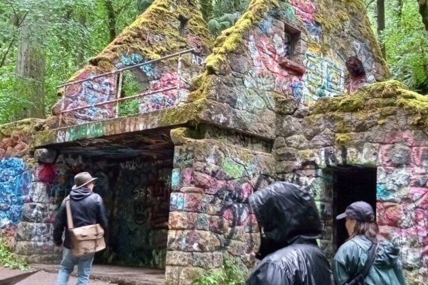 A graffiti-covered stone structure with a metal staircase. 1