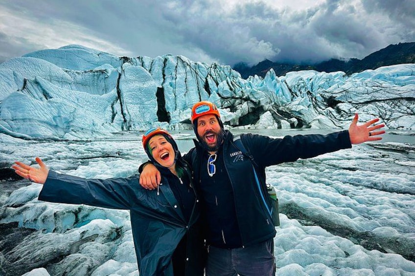 A glacier with ice formations and a cloudy sky. 5