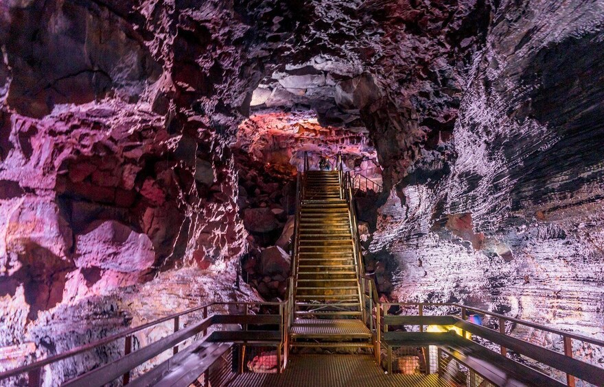A cave with a wooden staircase leading to a higher level. 5