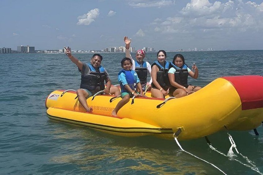A group of people on a yellow inflatable raft in the water. 3