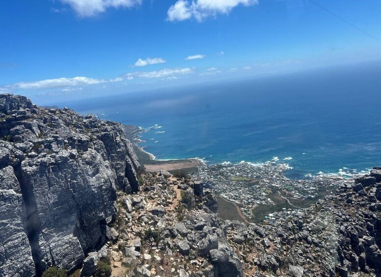 A rugged coastline with rocky cliffs and a view of the ocean. 3