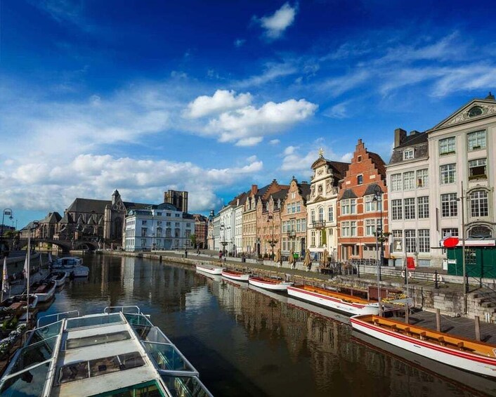 A canal with boats, historic buildings, and a church. 4
