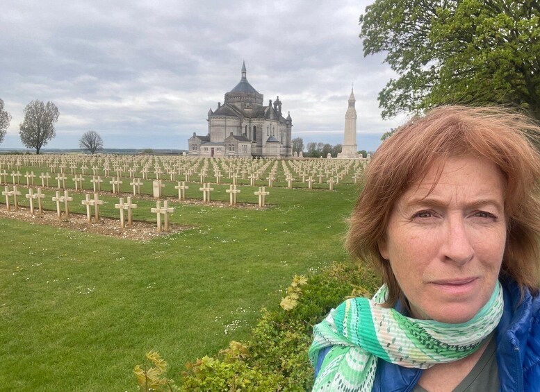 A cemetery with numerous crosses and a historic building in the background. 5