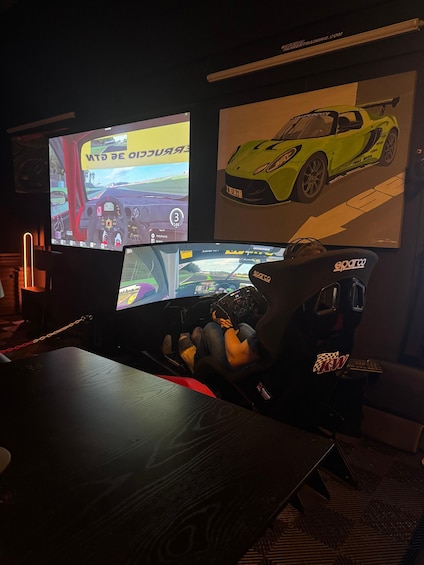A racing simulator setup with a driver in a racing suit, a racing wheel, and two screens displaying racing games. 2