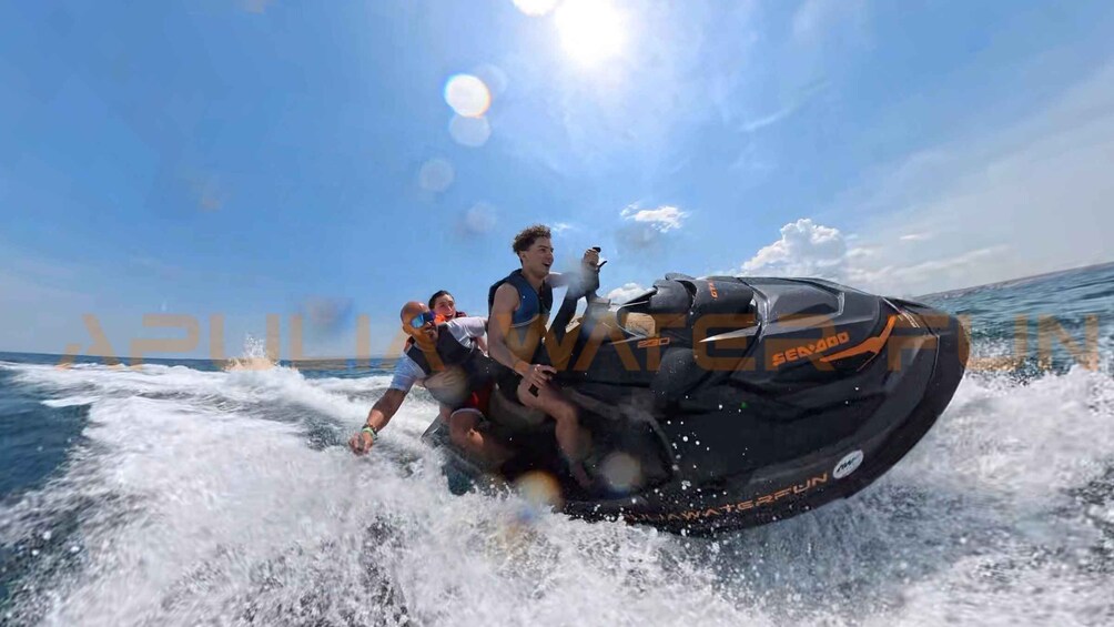 A jet ski with 'SEANOO' and 'WATERFUN' on the side, being ridden on the water. 1