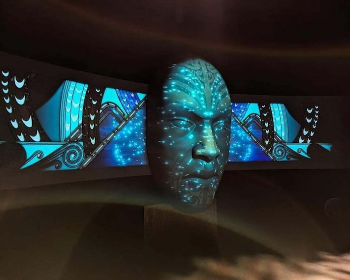 A sculpture with a blue light effect, surrounded by patterned wall panels. 5