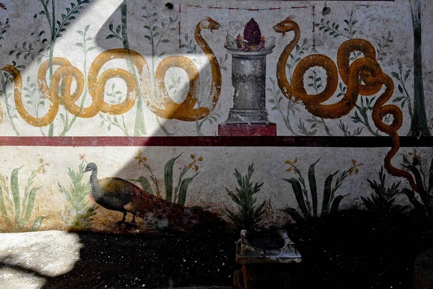 A mosaic with a bird, plants, and a snake. 3