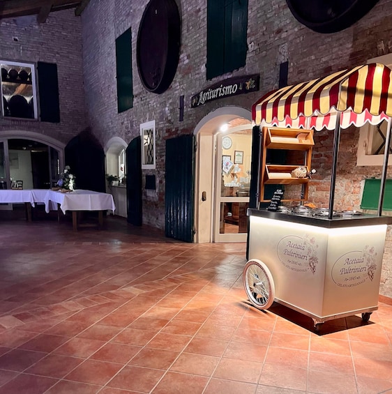 An indoor market with a gelato cart and a brick wall. 5