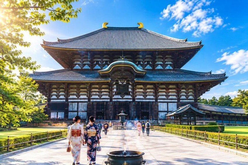 A traditional Japanese building with a large, ornate roof and a courtyard. 1