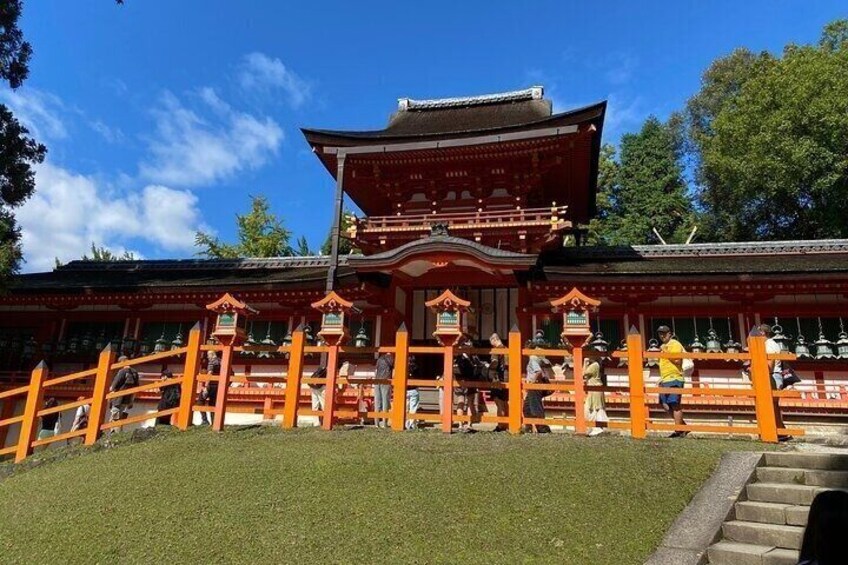 A traditional Japanese temple with a red roof and orange lanterns. 1
