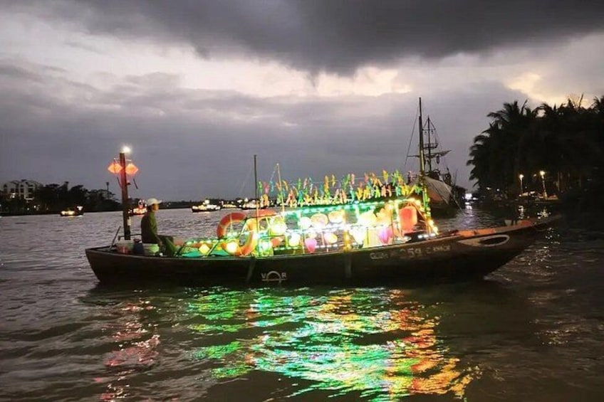 A boat with colorful lights and decorations on a body of water at night. 3