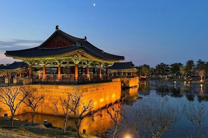A traditional Korean pavilion by a calm water body at dusk. 4