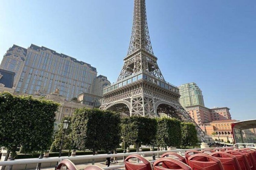 The Eiffel Tower with surrounding buildings and trees. 5
