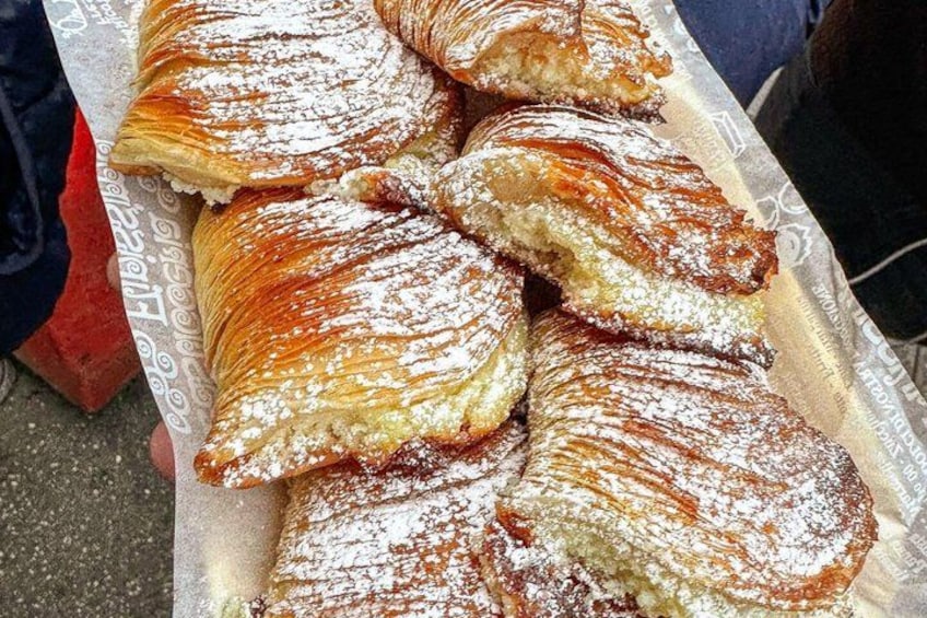 A tray of pastries dusted with powdered sugar. 3