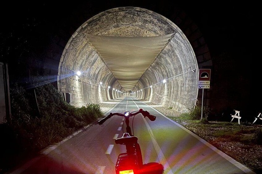 A motorcycle on a road leading to a tunnel. 3
