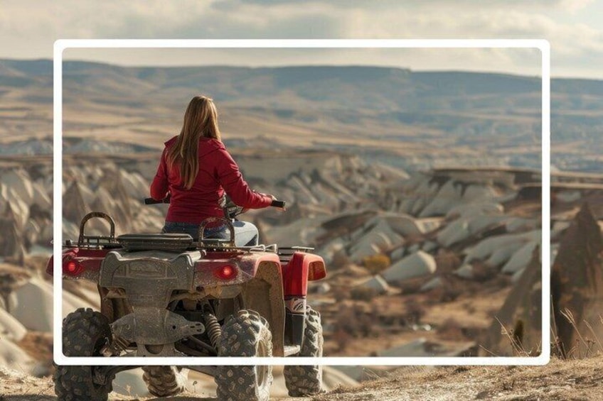 A person riding an ATV in a rocky, barren landscape. 1