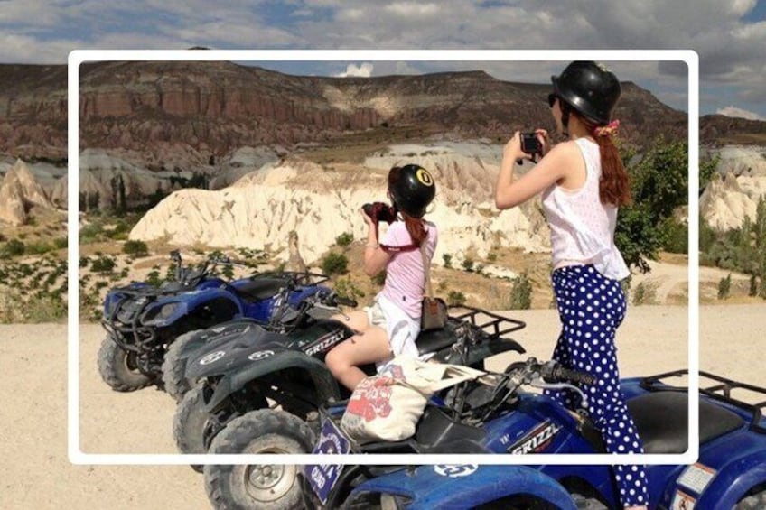 A person taking a photo of a child on a quad bike in a desert landscape. 2