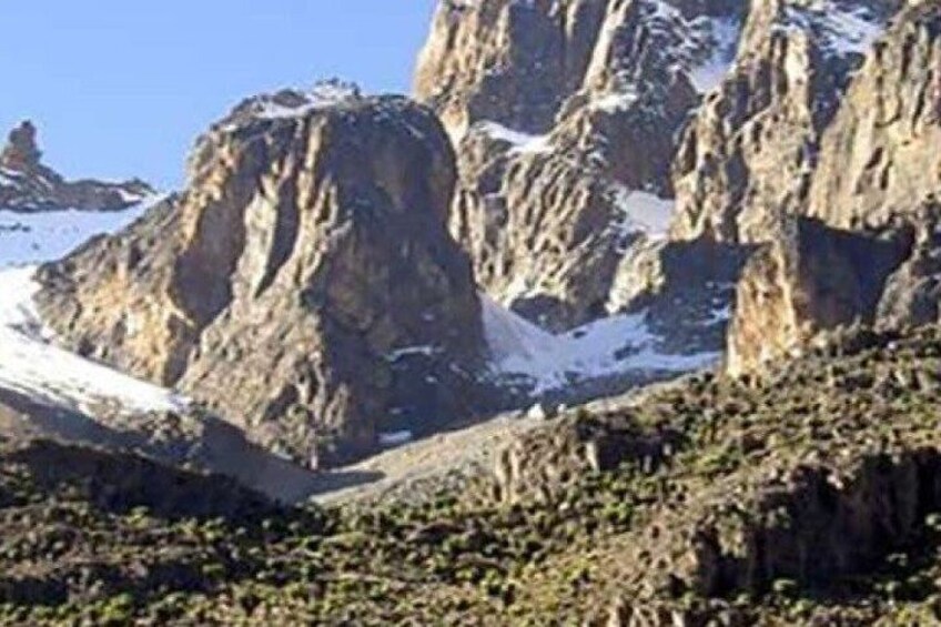 Rugged mountains with snow patches and sparse vegetation. 5