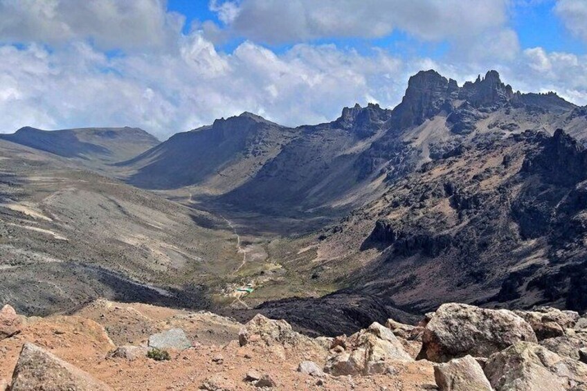 A mountainous landscape with rocky terrain and a valley. 3