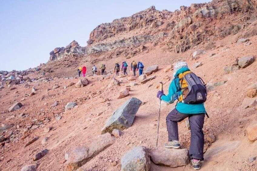 A group of hikers ascending a rocky mountain trail. 2
