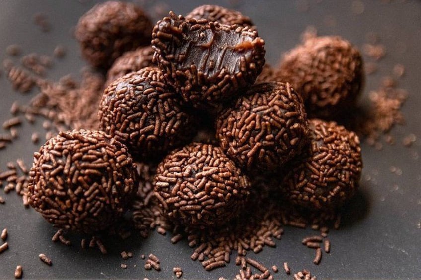 A pile of chocolate truffles with sprinkles. 3