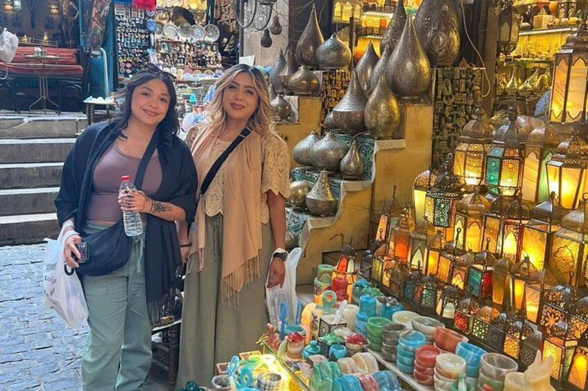 Dos personas frente a una tienda con faroles coloridos y adornos. 5