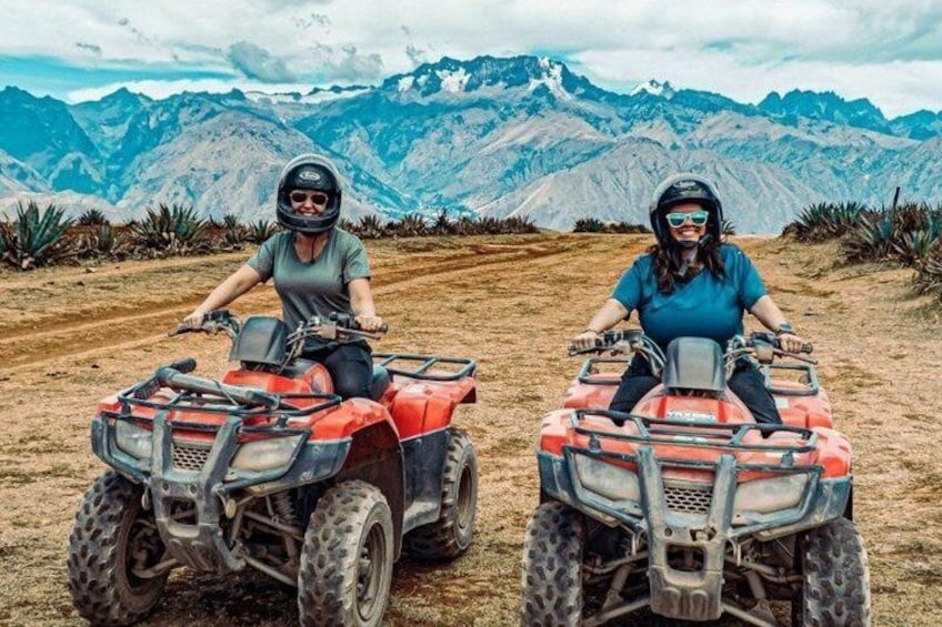 Two people on ATVs in a mountainous area. 4