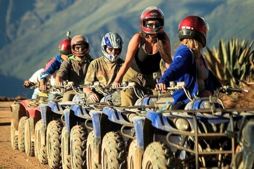 A group of people on ATVs in a desert landscape. 3