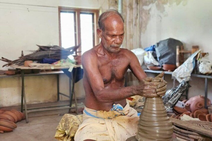A man working with clay pottery in a workshop. 2
