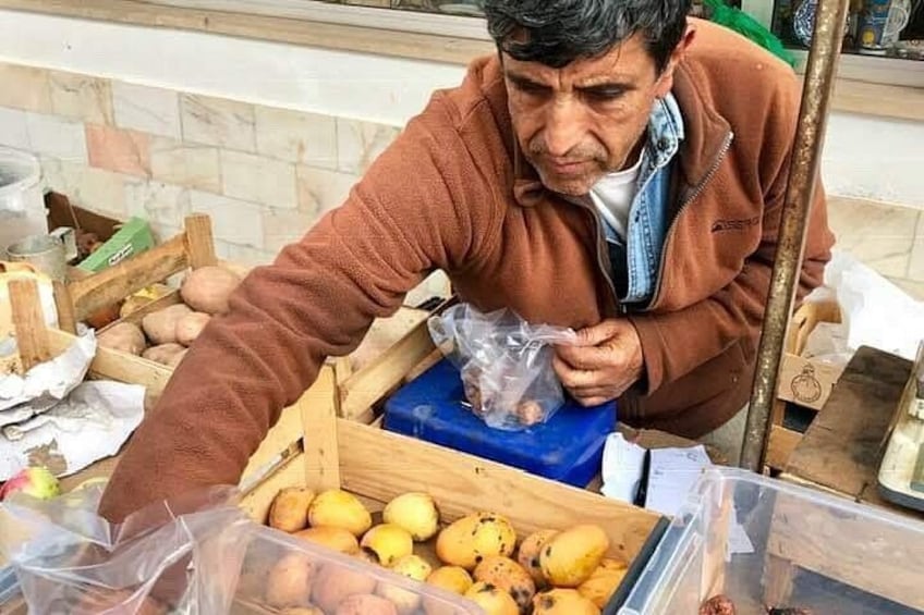 A person handling potatoes in a kitchen setting. 4