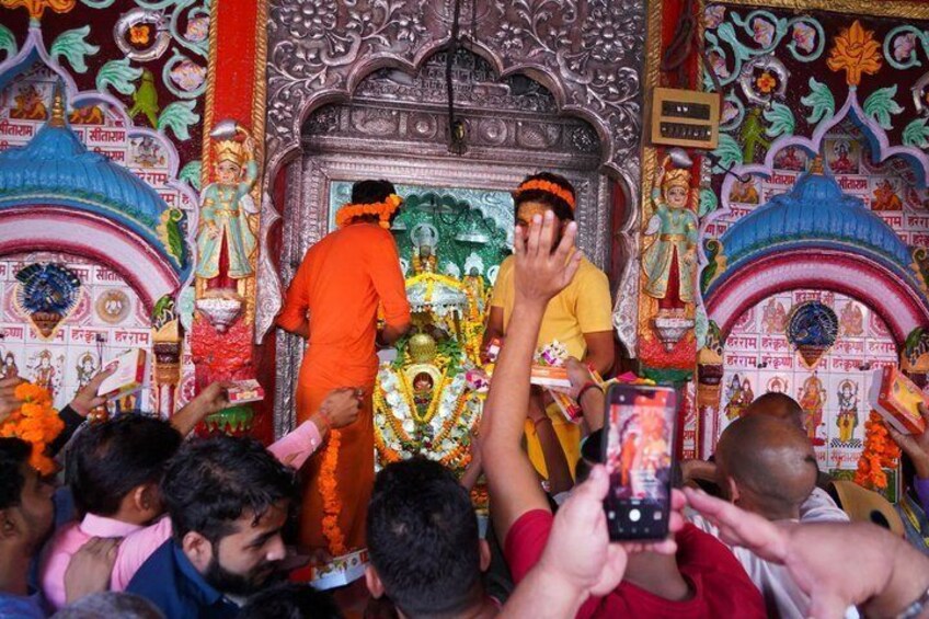A temple interior with ornate decorations and statues. 5