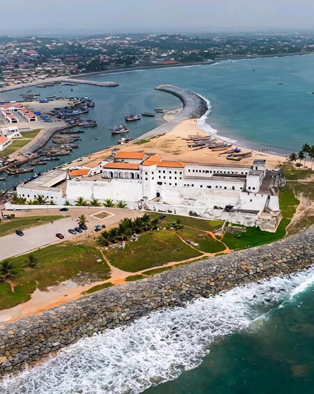 An aerial view of a coastal fort with a beach and a marina. 5