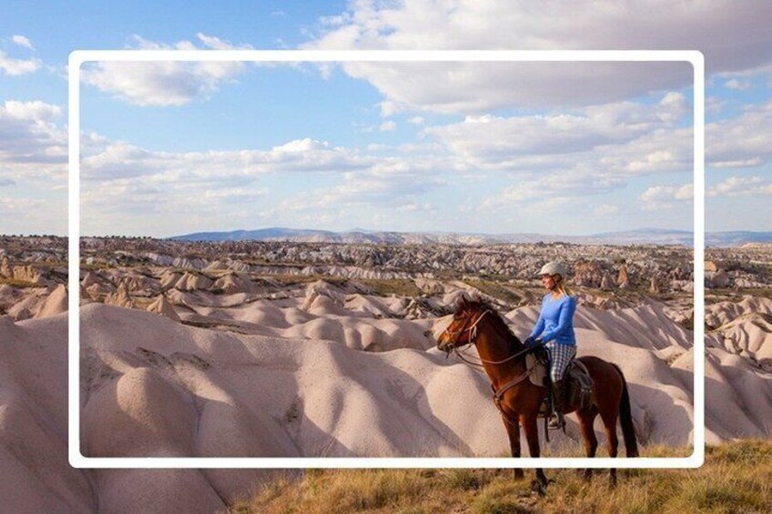A person riding a horse in a desert landscape with unique rock formations. 1
