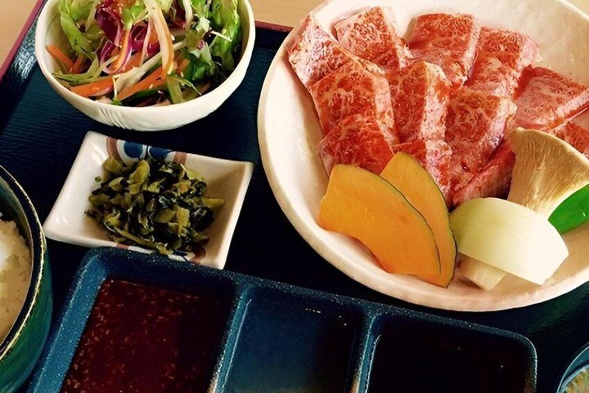 A meal with various dishes including a salad, sliced meat, and vegetables. 2