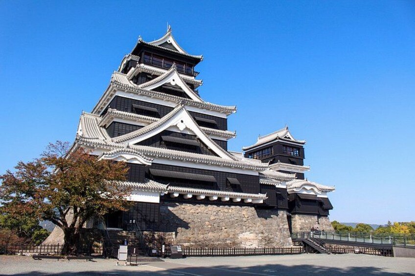 A traditional Japanese castle with multiple tiers and a stone base. 1