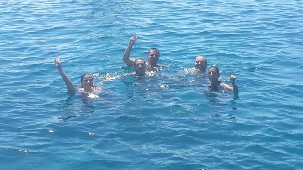 A group of people swimming in a body of water. 1