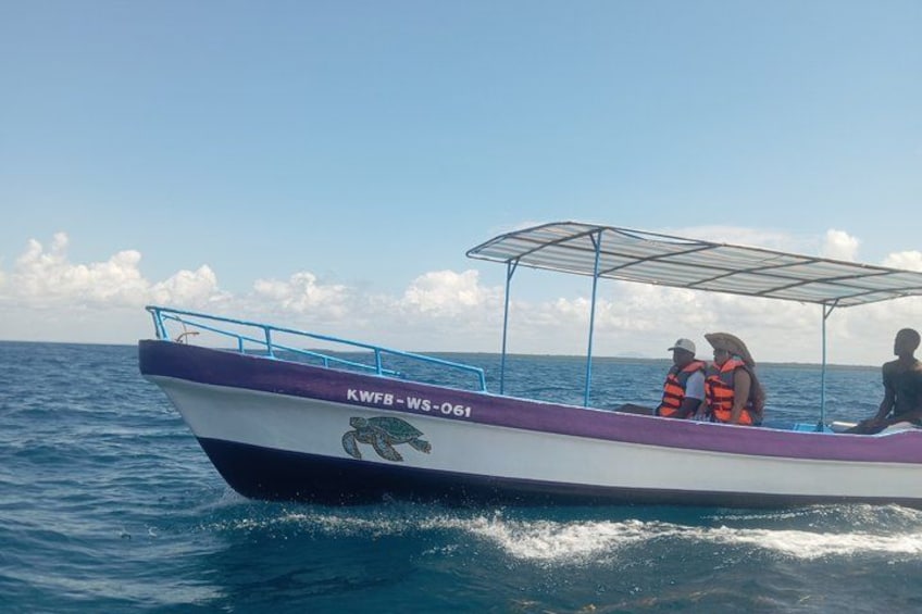 A boat with the registration number KWFB WS-06 on the water. 2
