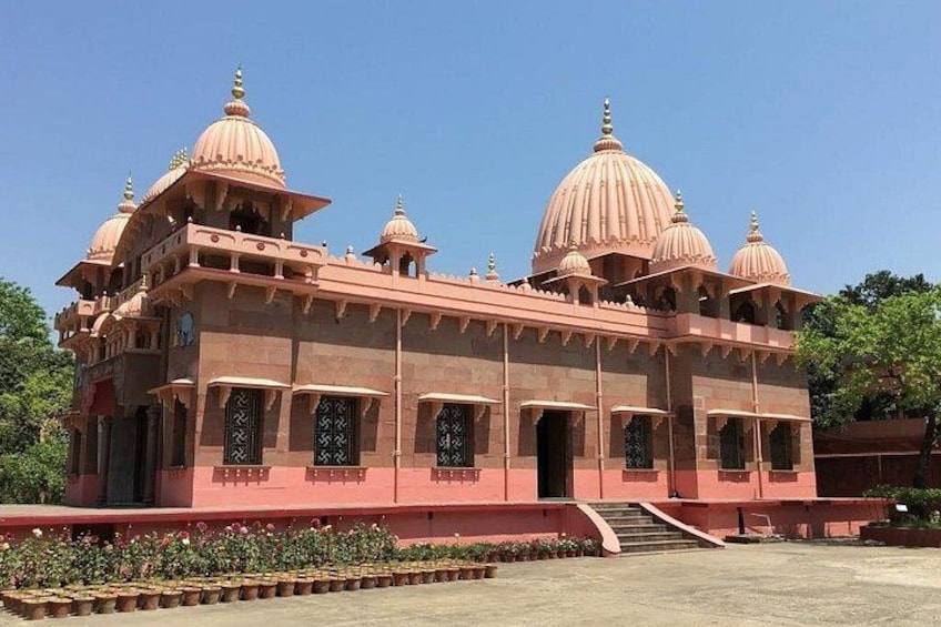 A pinkish-red building with multiple domes and arched windows. 4