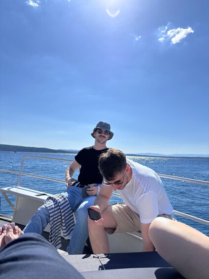 Two people on a boat with a clear sky and calm sea. 4