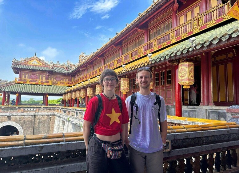 A traditional red and gold building with ornate decorations and a clear blue sky. 3