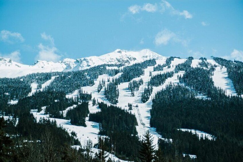A snow-covered mountain landscape with clear skies. 1