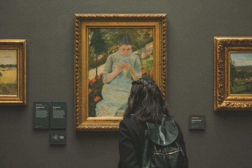 A person viewing a painting in an art gallery. 5
