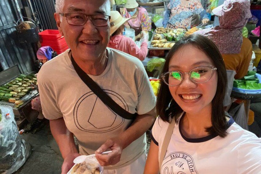 A market scene with people and various food items. 4