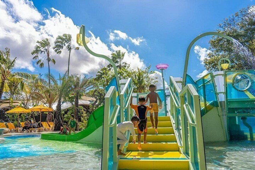 A water park with a pool, slides, and umbrellas. 2