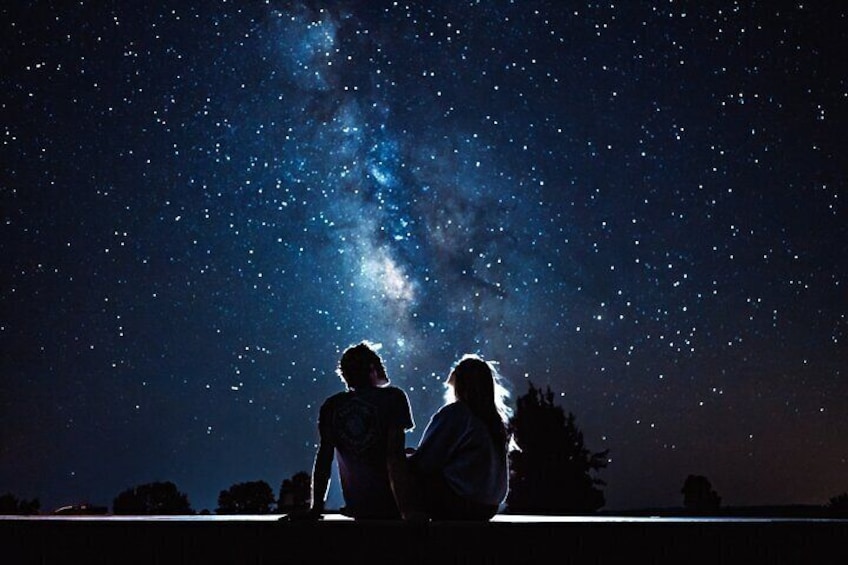 Two people sitting under a starry sky. 5