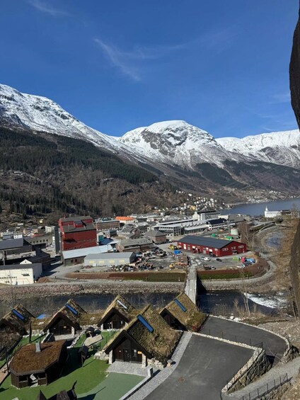 A town with buildings, a parking lot, and mountains in the background. 5